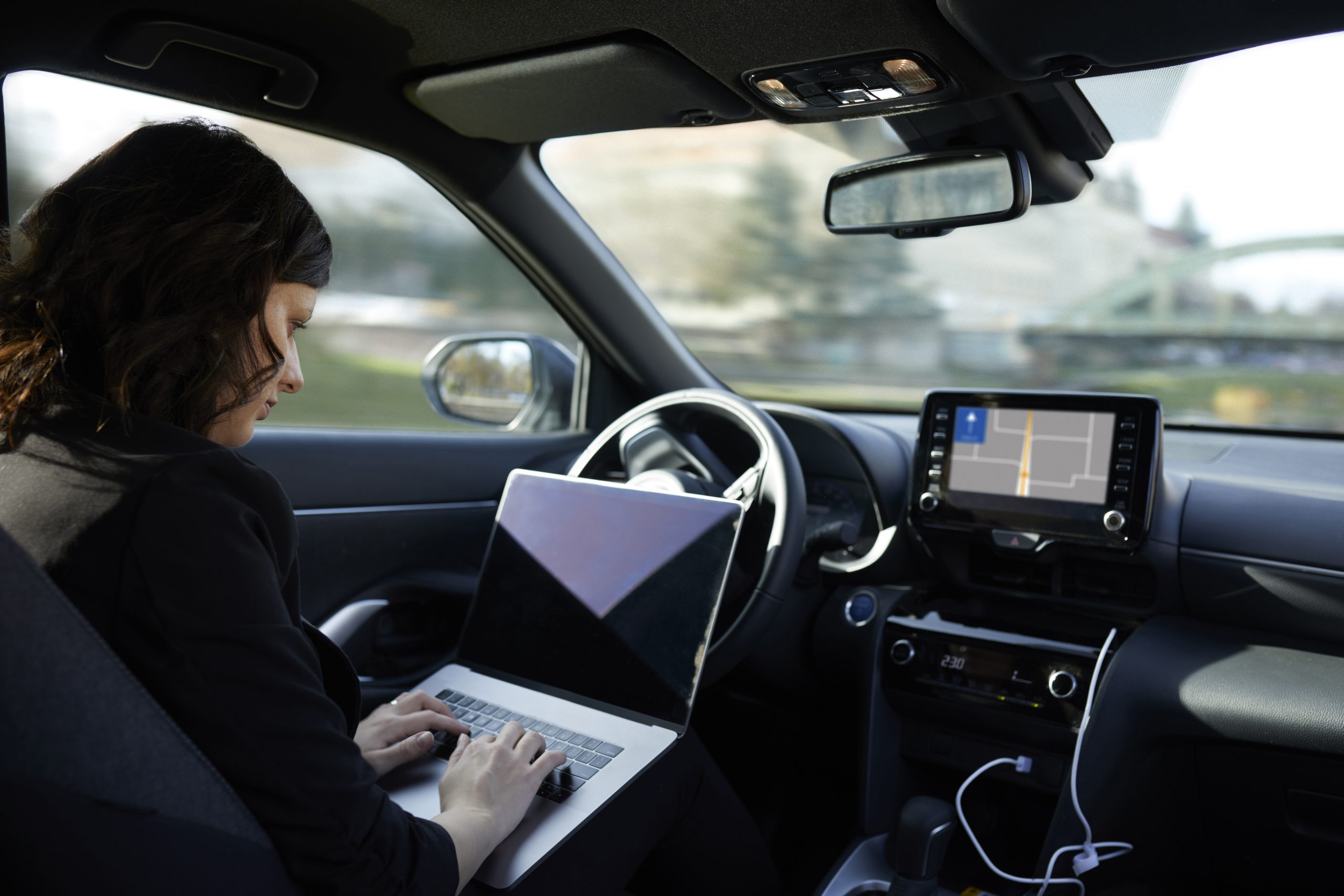 a person using a laptop in a car